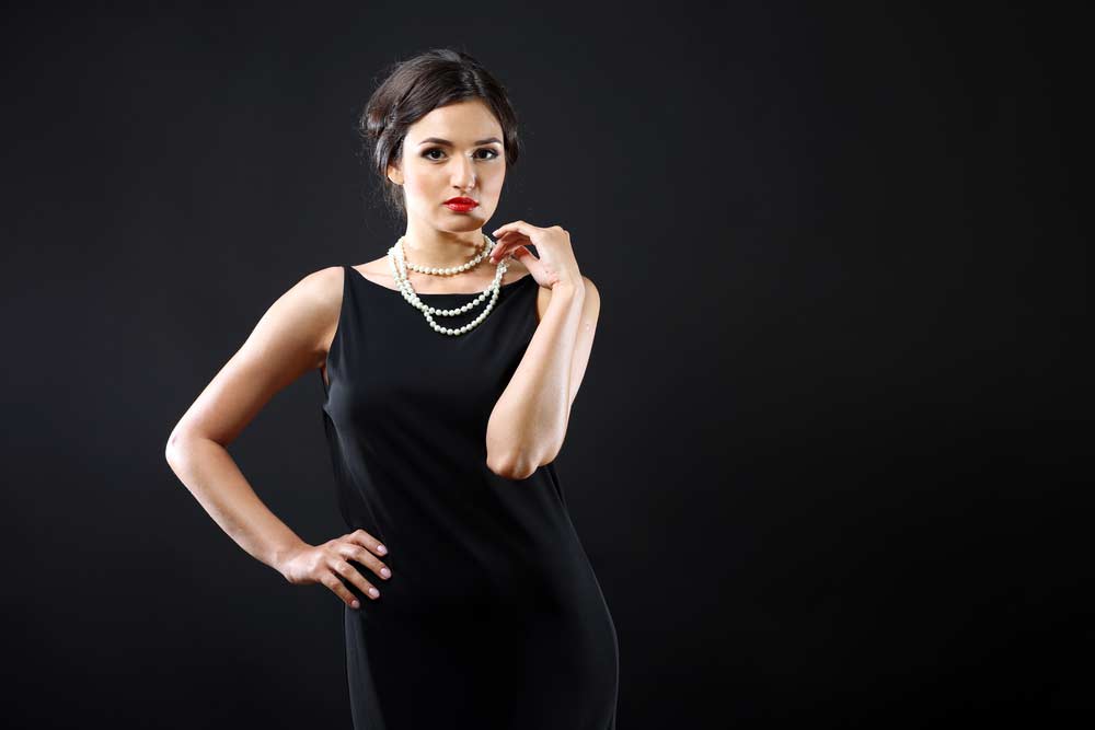 Schwarzes Abendkleid mit schlichter edler Perlenkette gestylt (de.depositphotos.com) Schwarzes Abendkleid mit schlichter edler Perlenkette gestylt (de.depositphotos.com)